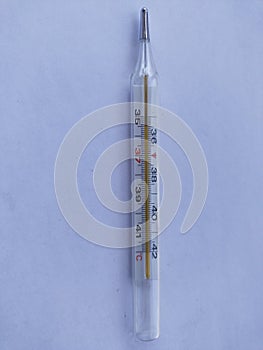 mercury thermometer for measuring body temperature isolated on white background
