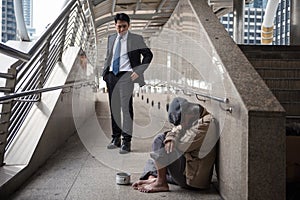 Mercy Businessman look at Homeless in city