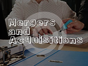 Mergers and Acquisitions M and A is shown on the conceptual business photo