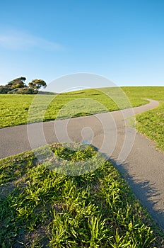 Merging Path on green landscape and blue sky