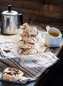 Meringue cake with chocolate, caramel and nuts, dessert, rustic