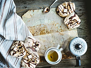 Meringue cake with chocolate, caramel and nuts, dessert, rustic