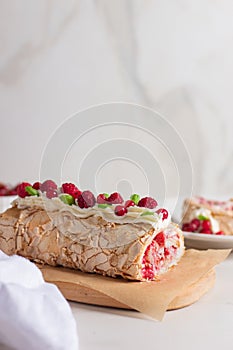 Meringue roll cake with berries whipped cream and Coffe. Summer dessert.