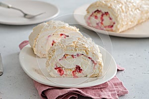 Meringue roll cake with cream, raspberries. Roulade, summer dessert. Confectionery, menu. Close up