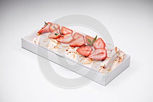 Meringue roll garnished with strawberry slices