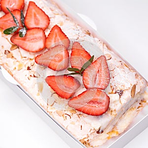 Meringue roll garnished with strawberry slices