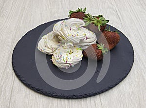 Meringues with the ingredients to create them including eggs and sugar photo