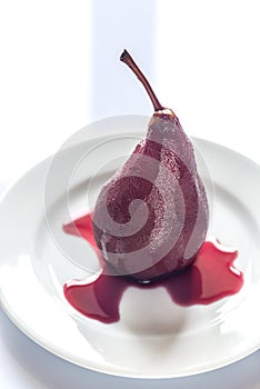 Merlot-poached pear on the plate