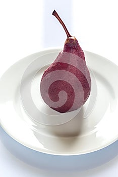 Merlot-poached pear on the plate