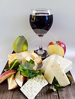 Merlot wine with cheeses and fruit.