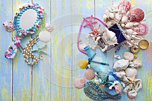 Mermaid`s treasures on a light peeled wooden light background with scratches and blur flat lay out of focus