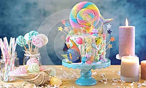 Mermaid theme candyland cake with glitter tails, shells and sea creatures. photo
