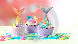 Mermaid theme cupcakes with colorful glitter tails, shells and sea creatures.