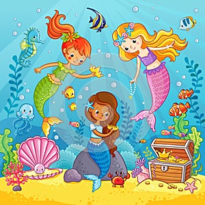 Mermaids play under the water.