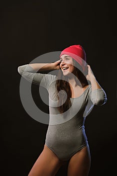 Merry brunette girl posing in studio during model tests dressed