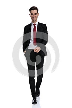 Merry businessman holding his hand in his pocket