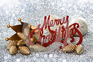 Merry christmas sign with crown and pinecone as christmas decoration