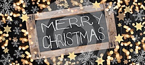 Merry Christmas background banner template - Top view from Chalkboard, bokeh lights, stars and ice crystals, isolated on dark