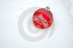 Merry Christmas background.Red Christmas ball snow in a winter snowy forest.Holiday themed wallpaper. Winter holidays