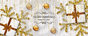 Merry Christmas background with shiny snowflakes, golden balls, gift boxes and gold colored tinsel and streamer