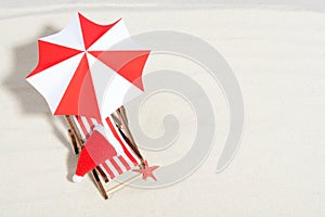 Merry Christmas on beach concept. Lounge chair with umbrella and Santa hat