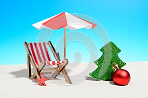 Merry Christmas on beach concept. Lounge chair with umbrella and Xmas decorations