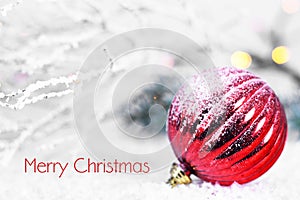 Merry Christmas card with Christmas ball in the snow