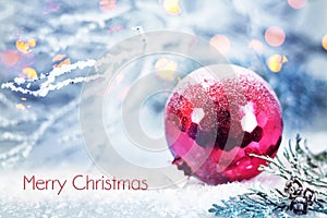 Merry Christmas card with Christmas ball in the snow