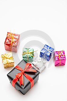 Merry Christmas card made of fir branches, gift boxes, red decoration, sparkles and confetti on white background