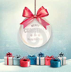 Merry Christmas card with a ribbon and gift boxes.