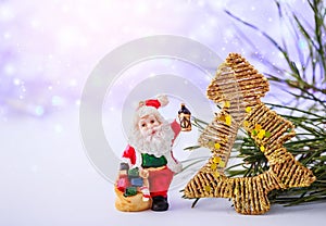 Merry christmas card with Santa Claus figurine. Lights background with space for text. Winter holidays. Xmas