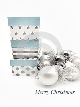 Merry Christmas card with silvered and golden balls in white background