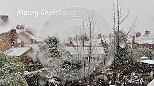 Merry Christmas card Snowing over rooftops