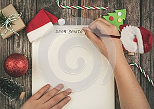 Merry Christmas.Christmas concept background. Child hands writing letter to santa claus