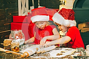 Merry Christmas. Christmas food and drink. Santa kids making cookie. Funny kids are preparing the dough playing with