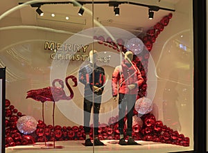 Merry Christmas clothing shop window,Winter fashion boutique display window with mannequins