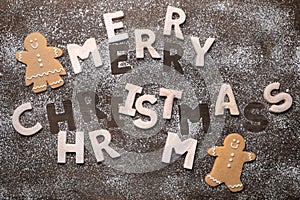 Merry Christmas With Cookie Letters on Wooden Background WithGingerbread People