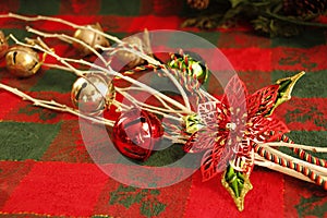 CHRISTMAS decorations,  white branches, jingle bells, red metal poinsettia flower