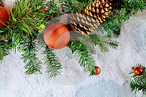 Merry Christmas decorative ball on snow with branch pine cone