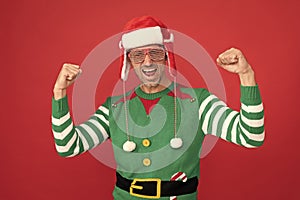 merry christmas. feel the success. happy shouting man in elf costume and party glasses.