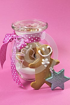 Merry Christmas festive gingerbread men in glass cookie jar cose up