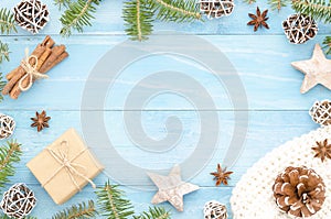 Merry Christmas frame for greeting card. Rustic blue wooden background with christmas tree, cinnamone,anice star, pine photo