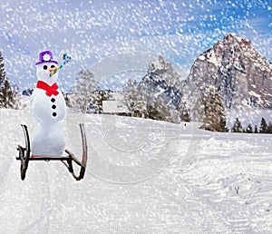 Merry christmas a funny party snowman sleighing down a ski hill slope on a sled in snowy weather