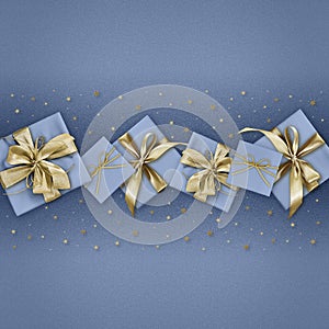 Merry christmas, gift box with golden ribbon bow isolated on blue sparkle background with stars, gift greeting card ticket top