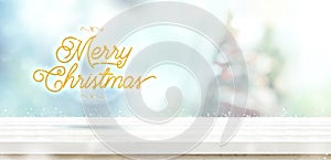 Merry Christmas gold glitter on white wooden table with abstract