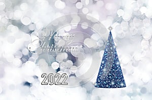 Merry Christmas greeting card with bokeh lights and Christmas tree isolated on snowing background