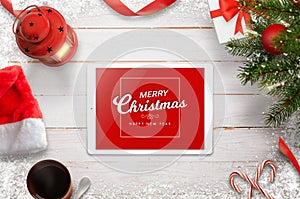 Merry Christmas greeting card with tablet, Christmas tree, gifts and decorations