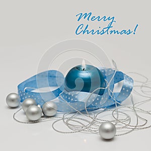 Merry Christmas greeting card template made of blue candle with blue ribbon, silver christmas balls and silver string of beads