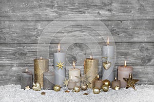 Merry christmas greeting card: wooden grey shabby chic background with candles.