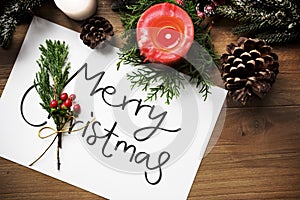 Merry Christmas greeting card on wooden table